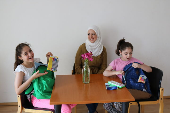 MutterJomana freuen sich über die neuen Schulsachen